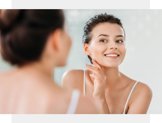 Woman showing off whitened teeth by Central Avenue Dentistry